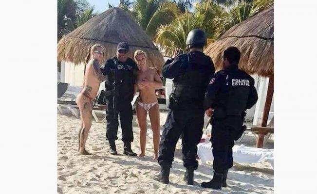 Suspenden a policías de Cancún por tomarse fotos con turistas en topless